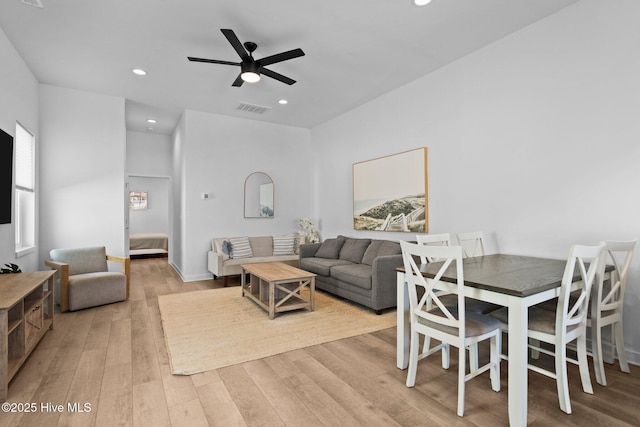 living room featuring light hardwood / wood-style floors and ceiling fan