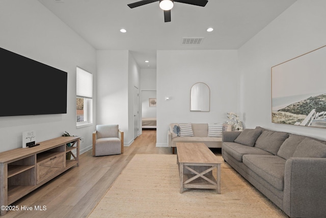 living room featuring ceiling fan and light wood-type flooring