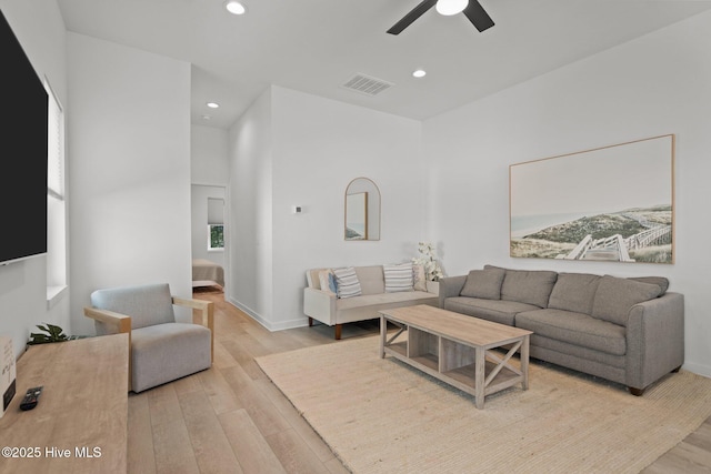 living room featuring ceiling fan and light wood-type flooring