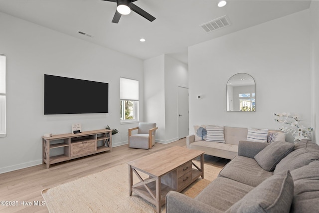 living room with ceiling fan and hardwood / wood-style floors