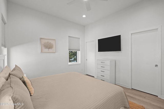 bedroom with light hardwood / wood-style floors and ceiling fan