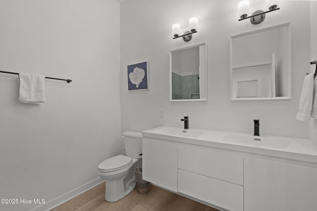 bathroom featuring vanity, wood-type flooring, and toilet