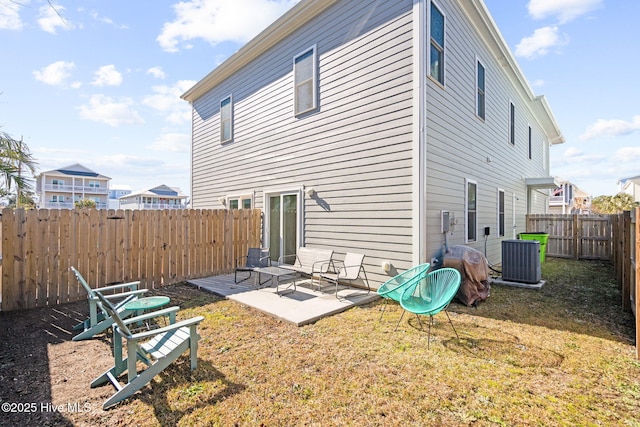 back of house with central AC unit, a patio, and a lawn