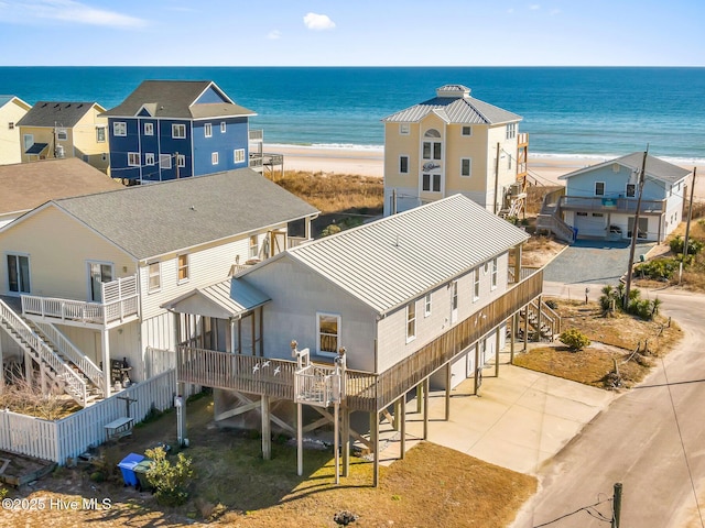 bird's eye view with a water view and a beach view