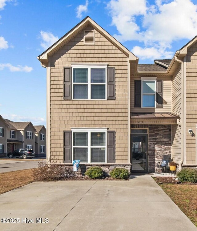 237 Boyington Place Rd, Midway Park, NC 28544 - view of property featuring concrete driveway, a residential view, stone siding, and a garage