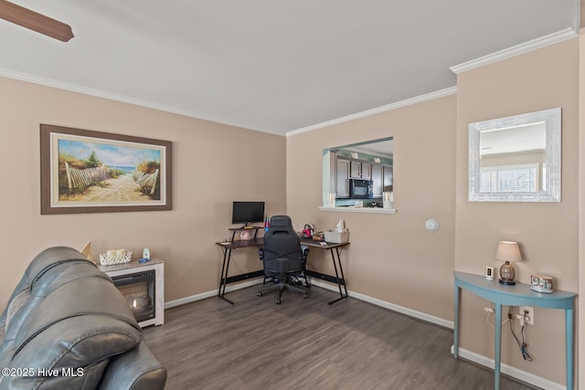 office space featuring crown molding, wood finished floors, and baseboards