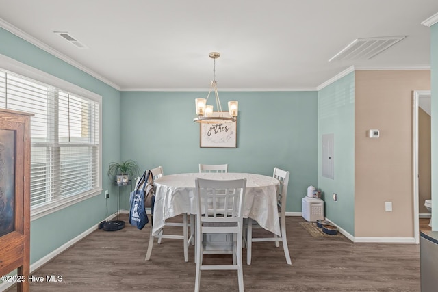 dining room featuring a notable chandelier, ornamental molding, dark wood-type flooring, and electric panel