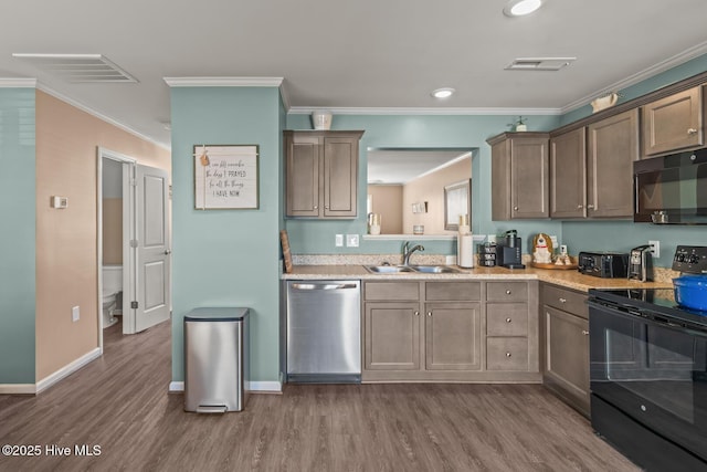 kitchen featuring dark hardwood / wood-style flooring, sink, ornamental molding, and black appliances