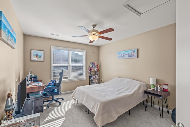 carpeted bedroom with visible vents, ceiling fan, attic access, and baseboards