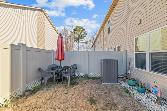 view of yard with central AC and a fenced backyard