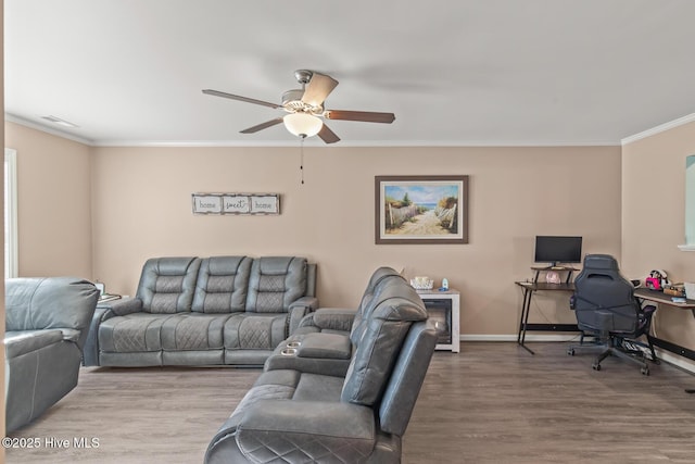 living room with crown molding, wood-type flooring, and ceiling fan