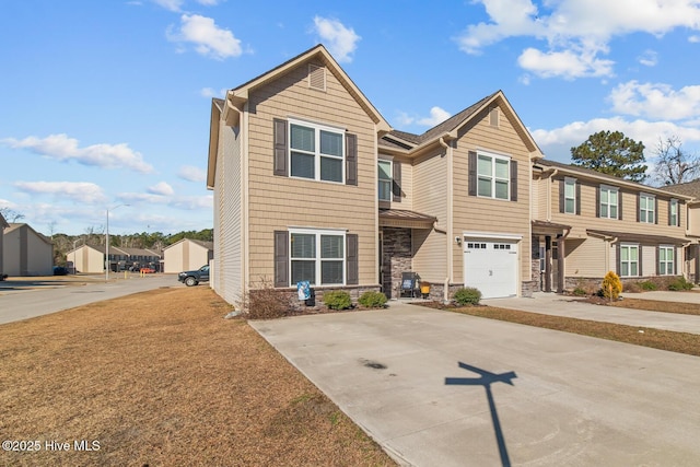 view of front facade with a residential view, stone siding, and driveway