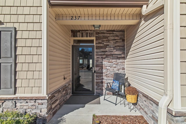 entrance to property featuring stone siding