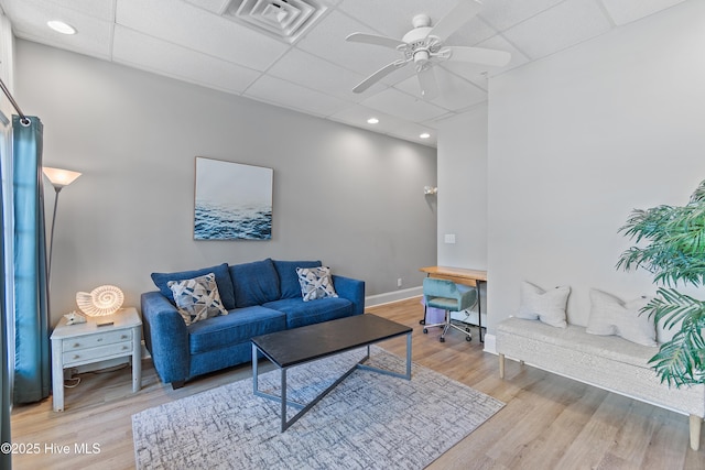 living room featuring ceiling fan, a paneled ceiling, and light hardwood / wood-style floors