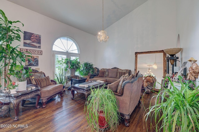 living room with a notable chandelier, high vaulted ceiling, and dark hardwood / wood-style floors