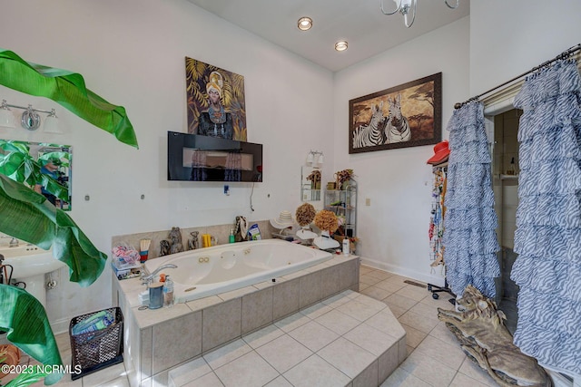 bathroom with tile patterned flooring and tiled tub