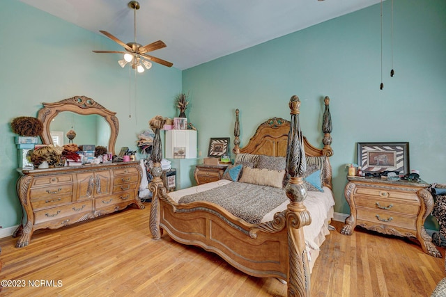 bedroom featuring ceiling fan, lofted ceiling, and light hardwood / wood-style floors