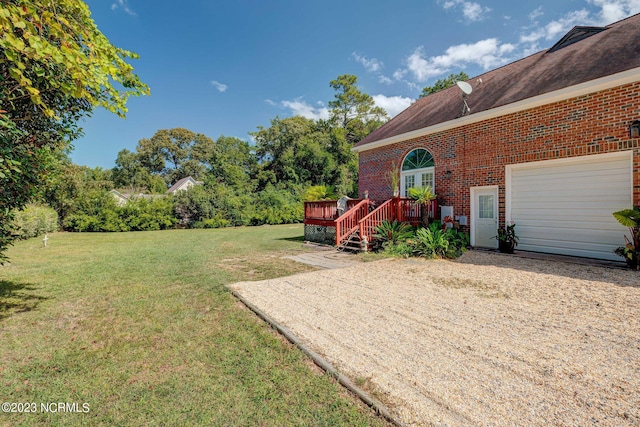 view of yard featuring a garage and a deck