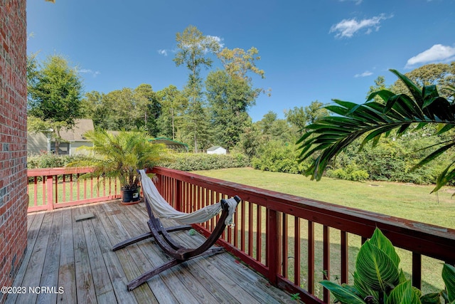 wooden terrace with a lawn