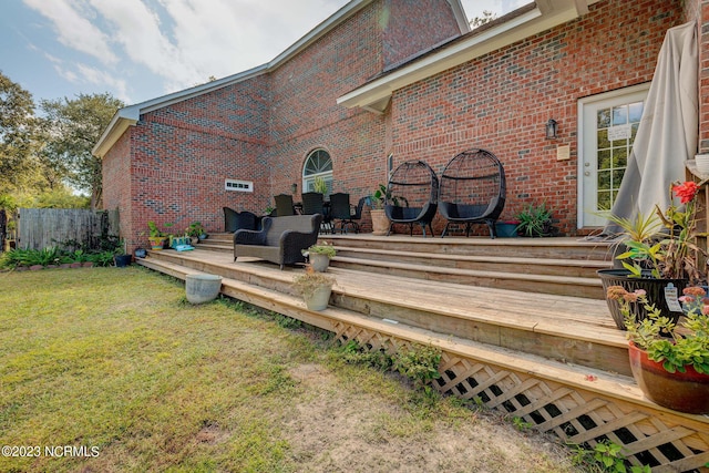 back of property with outdoor lounge area, a yard, and a deck