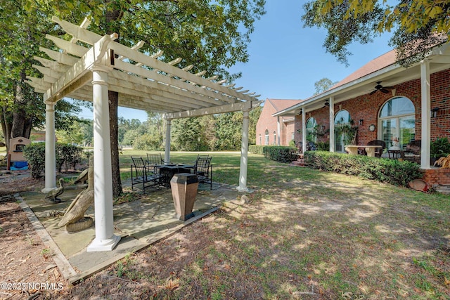 view of yard with a patio area, ceiling fan, and a pergola