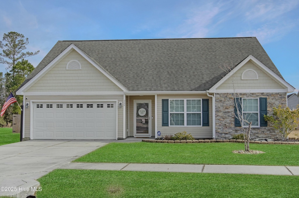 view of front of property with a garage and a front lawn