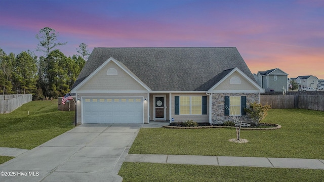 view of front of house featuring a garage and a lawn