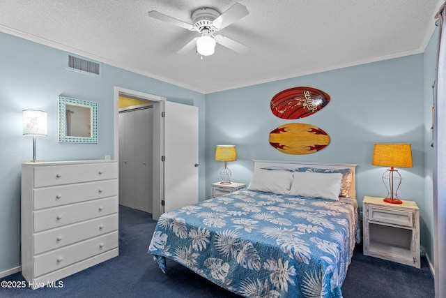 carpeted bedroom featuring crown molding, ceiling fan, and a textured ceiling