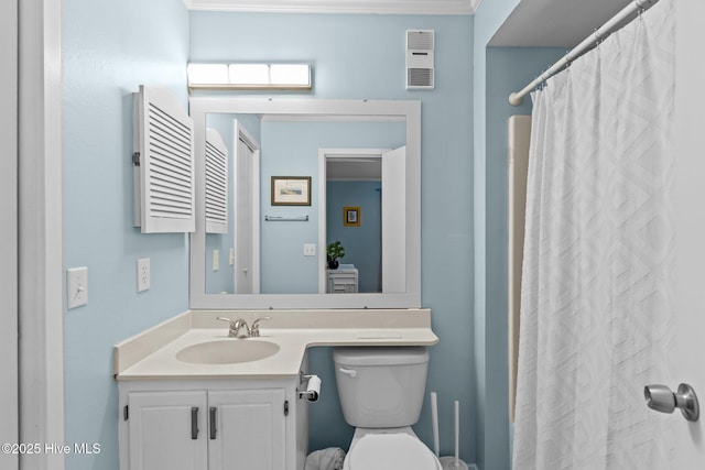 bathroom featuring vanity, walk in shower, and toilet