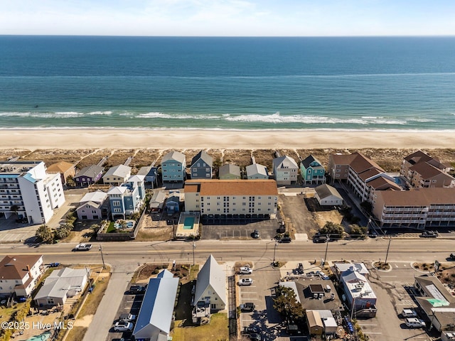 drone / aerial view featuring a beach view and a water view