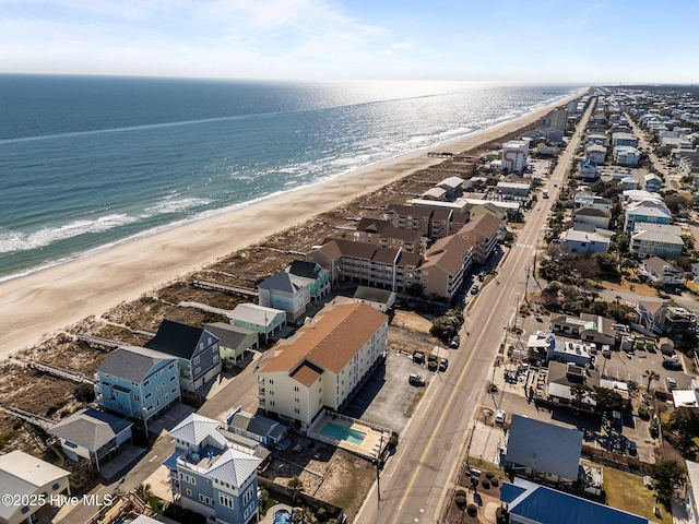 aerial view with a water view and a beach view