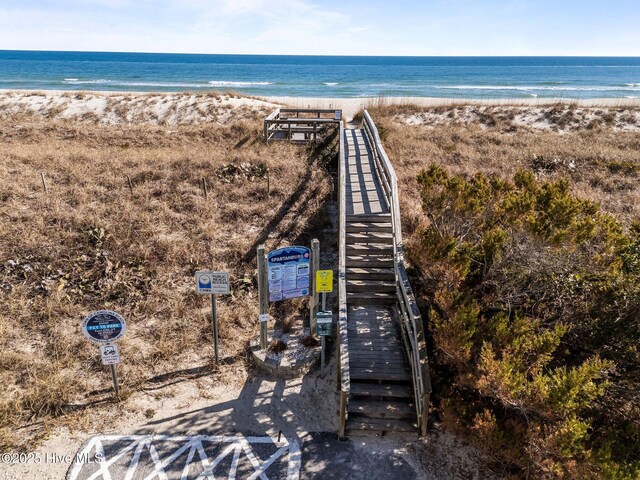 bird's eye view with a water view and a beach view