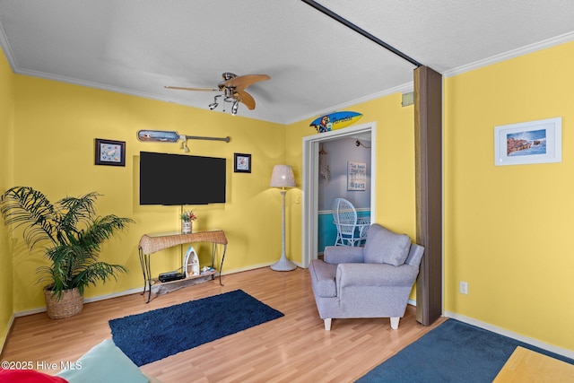 sitting room featuring crown molding, a textured ceiling, ceiling fan, and hardwood / wood-style flooring