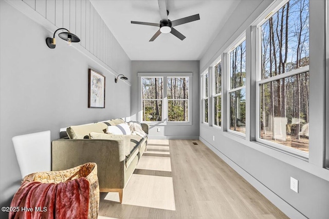 sunroom / solarium featuring ceiling fan