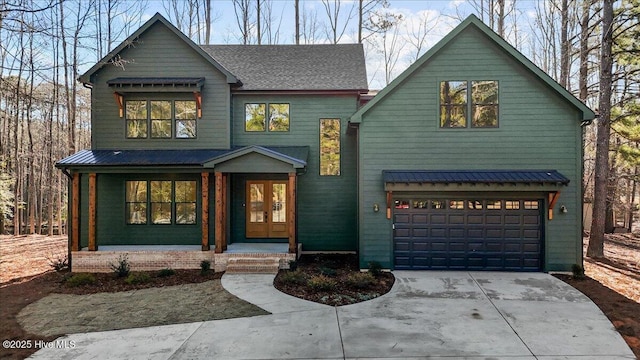 view of front of house with a garage and french doors