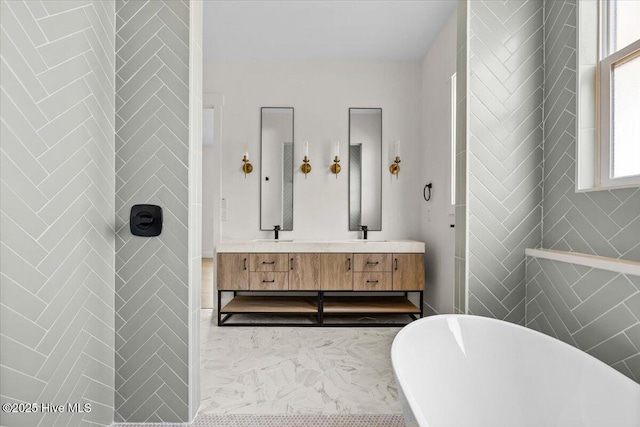 bathroom featuring vanity and a tub