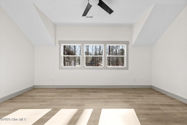 additional living space with ceiling fan and light wood-type flooring