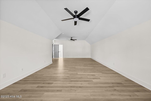 additional living space featuring ceiling fan, lofted ceiling, and light hardwood / wood-style floors