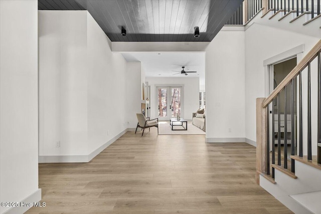 foyer with french doors, light hardwood / wood-style flooring, and wooden ceiling