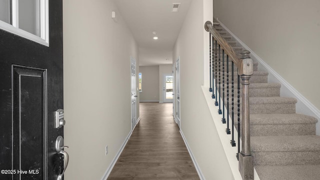 entrance foyer featuring stairs, dark wood finished floors, visible vents, and baseboards