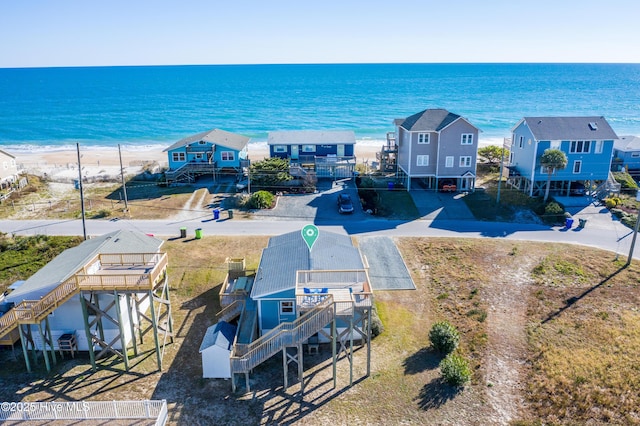 birds eye view of property with a water view and a view of the beach