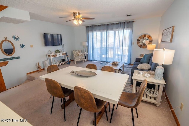 carpeted dining area featuring ceiling fan