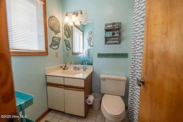 bathroom featuring vanity, tile patterned floors, and toilet