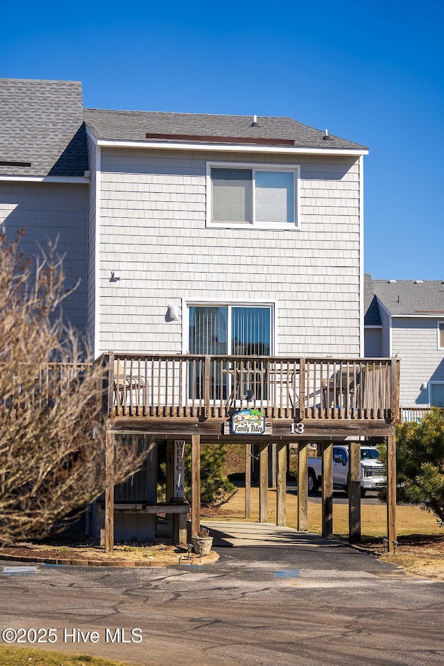 back of house featuring a wooden deck