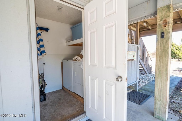 laundry area with washer and dryer and a textured ceiling