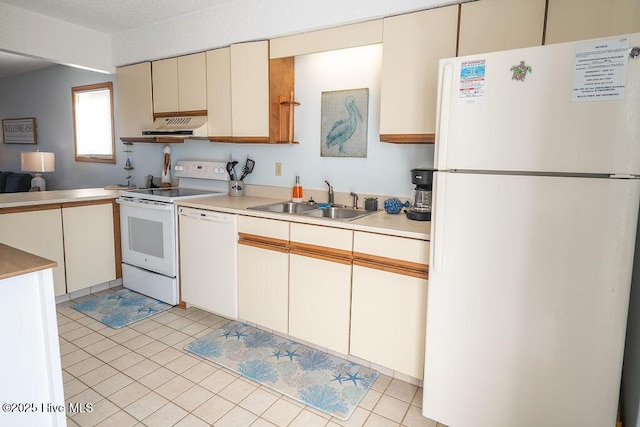 kitchen with light tile patterned flooring, sink, and white appliances