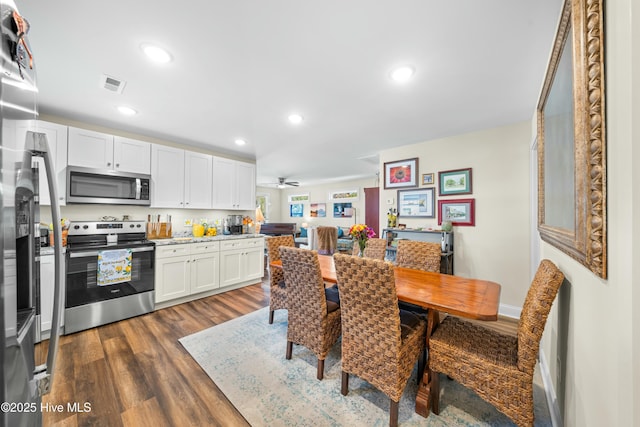 dining area with dark hardwood / wood-style floors and ceiling fan