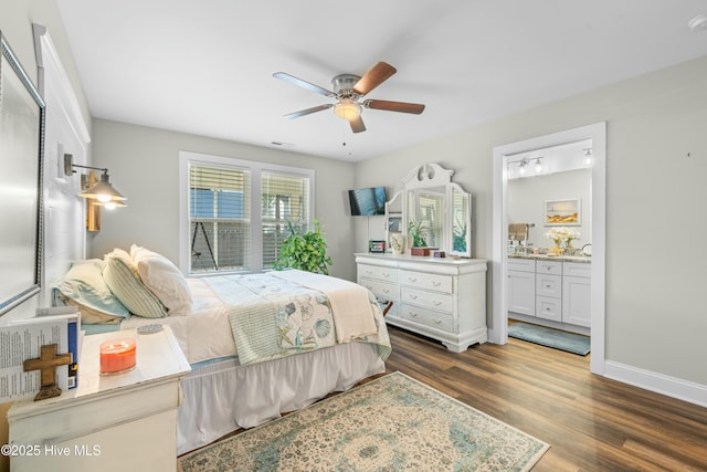 bedroom featuring ceiling fan, ensuite bath, and dark hardwood / wood-style floors