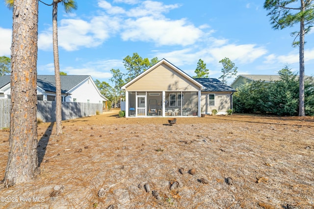 back of property with a sunroom