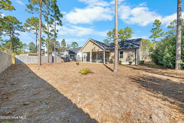 back of property with a sunroom